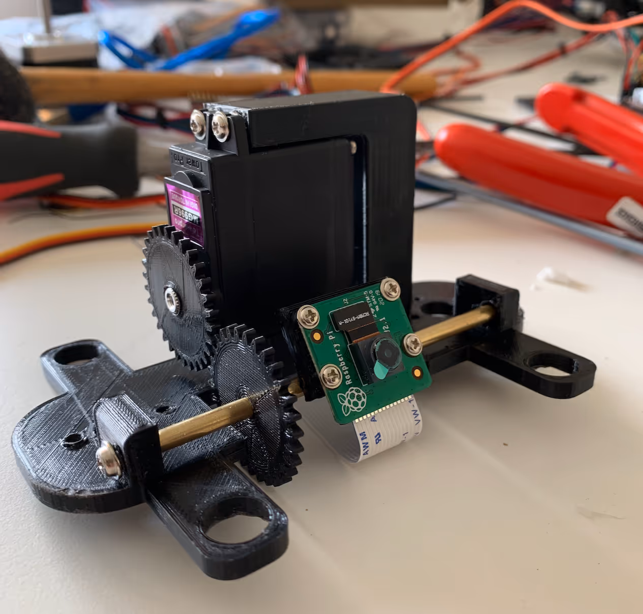 3D-printed camera pan module with printed gear pair, servo drive and Raspberry Pi camera board